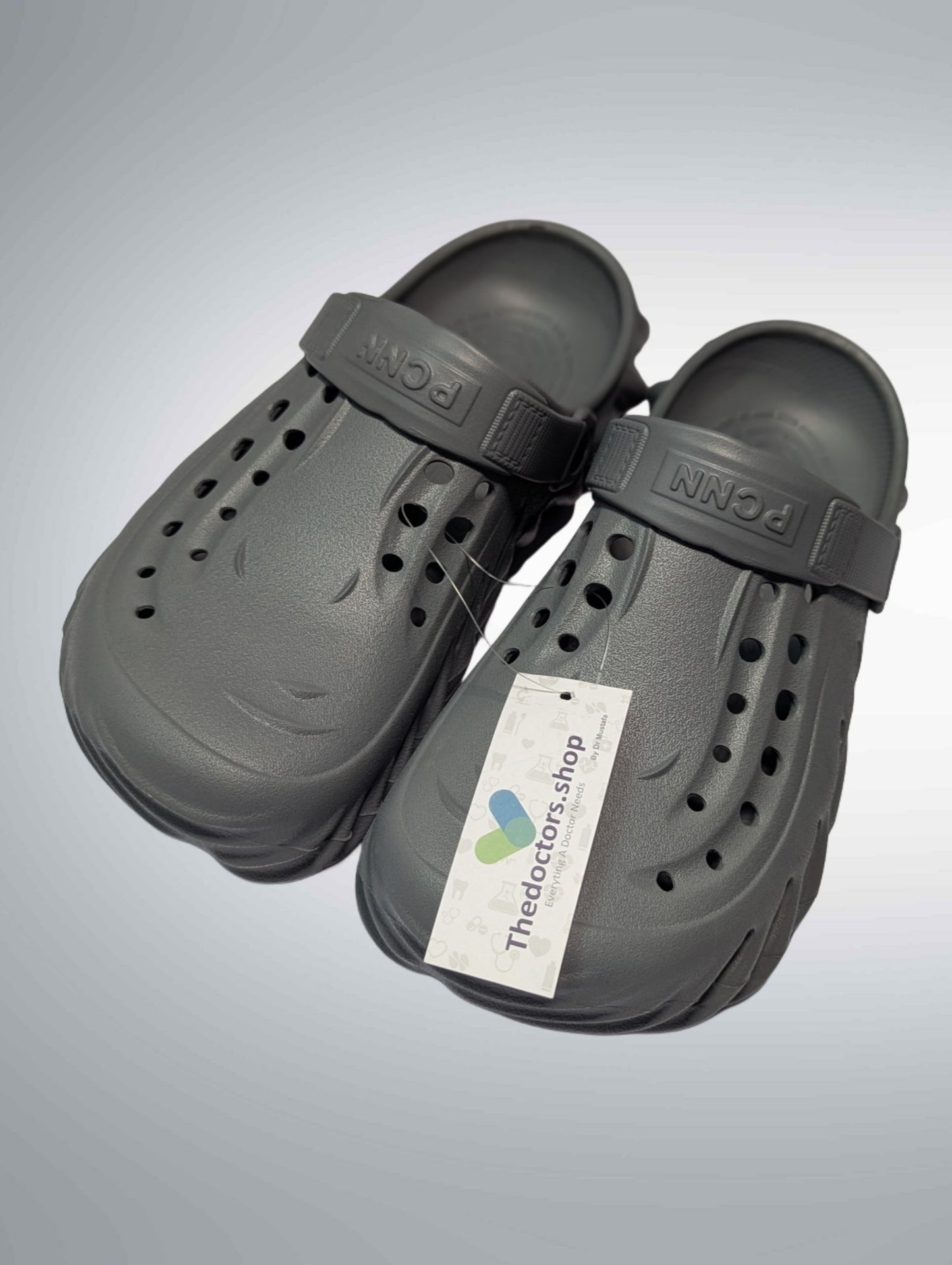 Pair of beige PGM medical clogs with ventilation holes and adjustable heel strap, displayed with TheDoctors.shop tag
