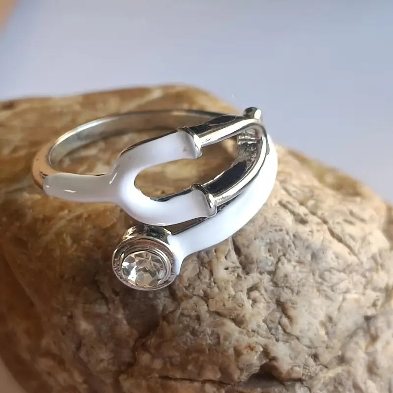 A stylish, transparent hand ring shaped like a stethoscope, designed for medical professionals and healthcare enthusiasts.