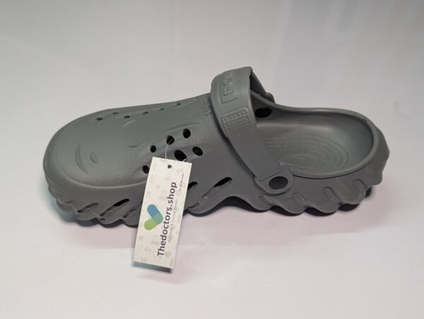 Pair of beige PGM medical clogs with ventilation holes and adjustable heel strap, displayed with TheDoctors.shop tag