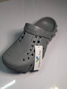 Pair of beige PGM medical clogs with ventilation holes and adjustable heel strap, displayed with TheDoctors.shop tag