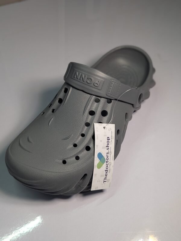 Pair of beige PGM medical clogs with ventilation holes and adjustable heel strap, displayed with TheDoctors.shop tag