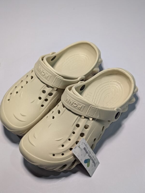 Pair of beige PGM medical clogs with ventilation holes and adjustable heel strap, displayed with TheDoctors.shop tag