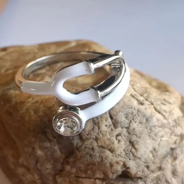 A stylish, transparent hand ring shaped like a stethoscope, designed for medical professionals and healthcare enthusiasts.